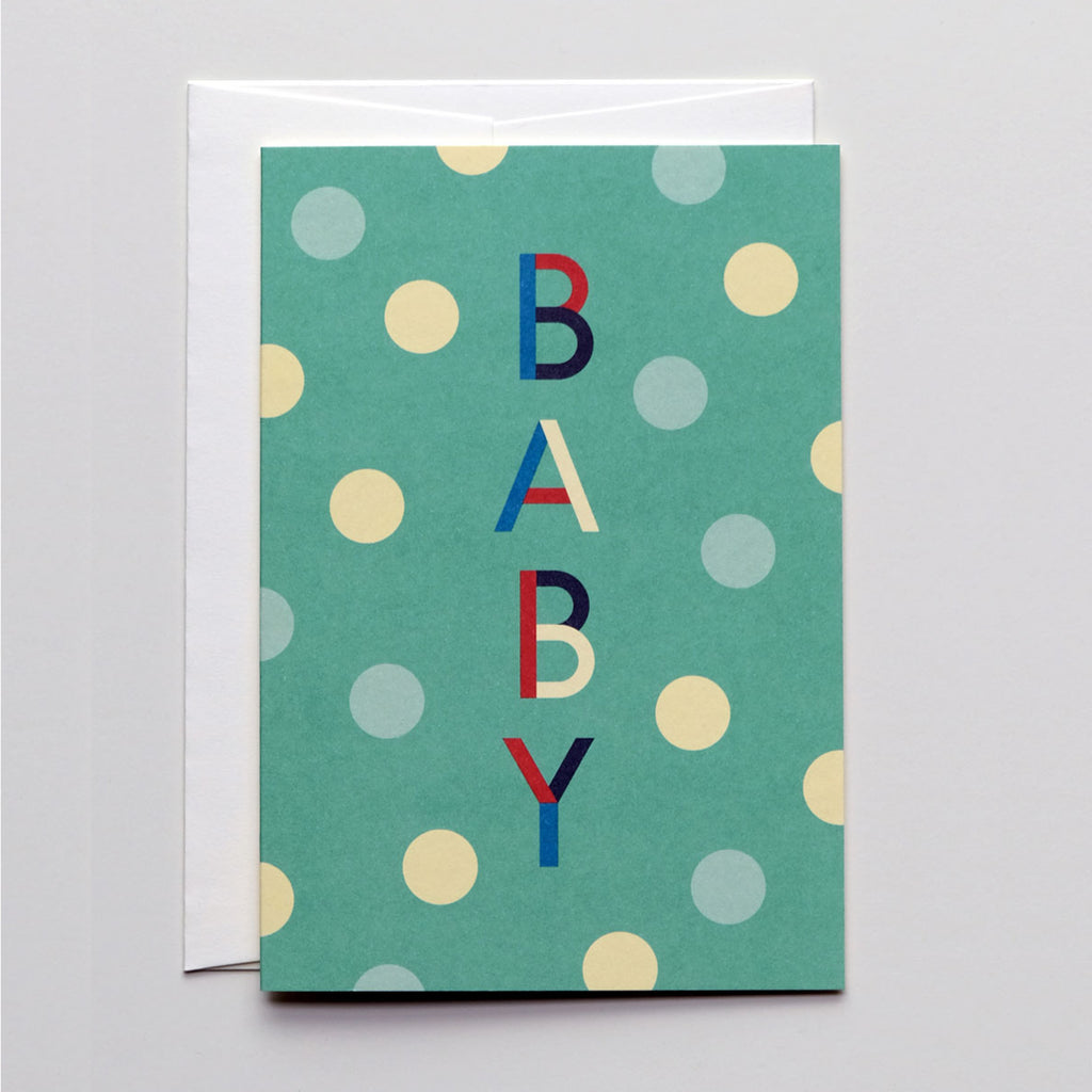 Grußkarte in türkis mit Polka Dots in hellblau und creme, zentral von oben nach unten in Großbuchstaben "BABY"